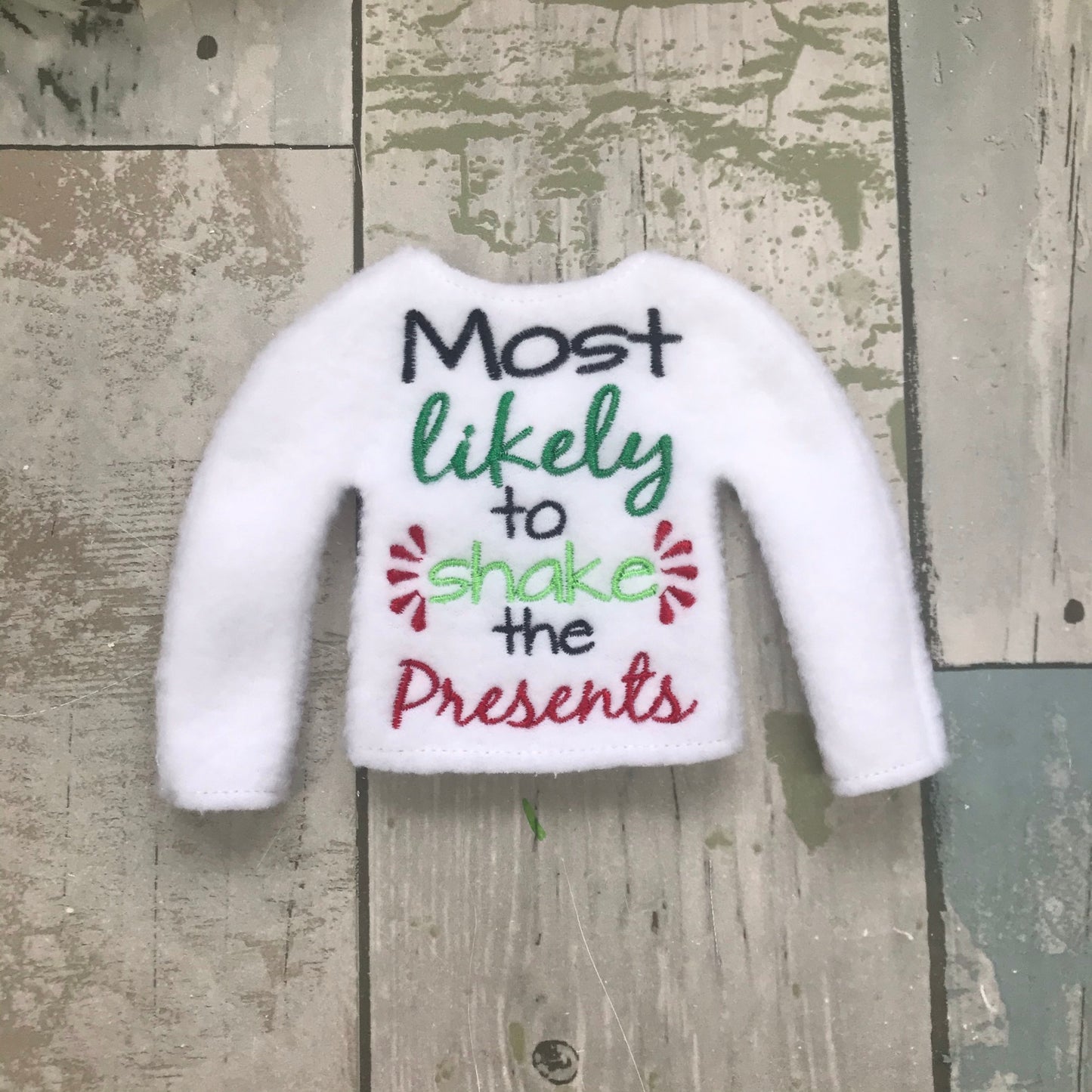 Most likely shake all the presents Elf Sweater